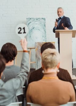 selective-focus-of-auctioneer-holding-talking-with-2024-11-07-16-35-34-utc-min